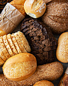 Assortment of baked bread on a white wooden background