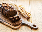 Top view of a sliced wholemeal bread on a wooden table