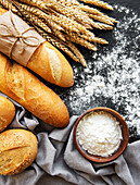 Assortment of baked bread on a black concrete background