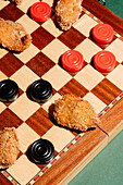 Crispy chicken nuggets in a chequerboard pattern that combine food and fun in a creative presentation. Perfect for a casual meal or playful food photography.