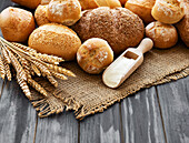 Assortment of baked bread on an old wooden background
