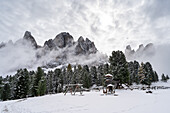 Snow-covered Geisleralm in the Dolomites, Italy Majestic peaks rise behind the tranquil winter landscape, offering a blend of natural beauty and tranquillity