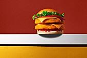A crispy chicken burger with fresh vegetables, cheese and a soft bun, presented on a vibrant background