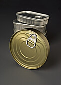 Detailed close-up of a stack of cylindrical food cans with practical pull-tab lids for convenient storage and easy access. Ideal for the food industry and packaging concepts.