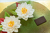 A beautifully decorated Italian cake with delicate edible flowers and vibrant leaves Ideal for celebrations, this dessert showcases exquisite craftsmanship