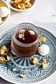A delicious homemade vanilla mini zephyr jam filled with rose jam, paired with a refreshing coffee liqueur drink served over ice.