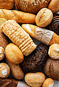 Assortment of baked bread on a white wooden background