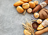 Assortment of baked bread on a grey concrete background