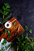 Preparation of homemade bouquet garni with parsley, bay leaves, sage, rosemary and celery leaves.