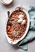 Apple and rhubarb crisp in an oval baking dish