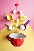 Modern baking concept flatlay with pink and yellow retro colour block aesthetics.