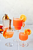 Blood Orange Margaritas on a tiled table with a grey background