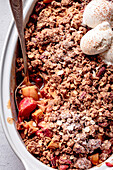 Apple and rhubarb crisp in an oval baking dish