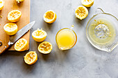 Squeeze the lemons with a knife and a measuring cup of juice onto a wooden board and worktop.