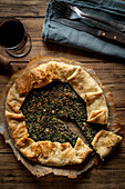 Bean cake with spinach flavour on a warm wooden background. View from above.