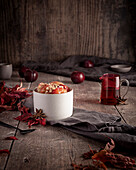 Baked autumn fruits with chopped nuts and maple syrup