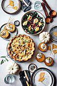 Autumnal festive meal with quiche, salad and pumpkins