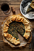 Bean cake with spinach flavour on a warm wooden base. View from above.