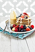 Buckwheat pancakes with fresh berries and vanilla sauce