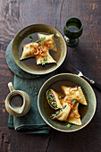 Wild ravioli with bacon and melted onions