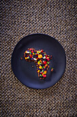 Fruit crumble in the shape of Africa with hibiscus and cocoa
