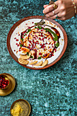 Papdi Chaat (Indian snack) made from crispy puris, yoghurt and chutneys