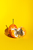 Broken granadilla against a yellow background