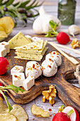 Rustic vegan cheese platter with radishes and crisps
