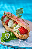 Eclair with pistachio ice cream and strawberries