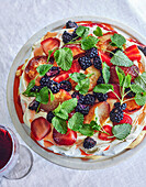 Strawberry pavlova with strawberries, blackberries and peaches