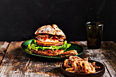 Vegan burger with deep-fried onion rings