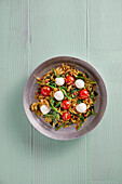Orzo pan with baby spinach, pesto, cured ham and baby mozzarella