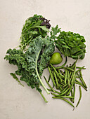 Fresh local produce from the market. Top view various green ingredients for cooking healthy vegetarian meal