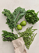 Fresh local produce from the market. Top view various green ingredients for cooking healthy vegetarian meal