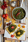 Polenta crostoni with agretti and cherry tomatoes