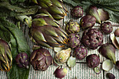 Artichokes and small carciofini on patterned tiles