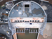 Aerial view of Seine River Retention Basin with industrial construction site and machinery, Gravon, France.