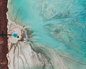 Aerial view of an abstract blue and turquoise clay lake, Art-sur-Meurthe, France.