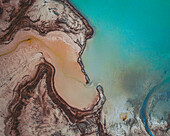 Aerial view of an abstract blue and turquoise clay lake, Art-sur-Meurthe, France.