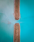 Aerial view of an abstract blue and turquoise clay lake, Art-sur-Meurthe, France.