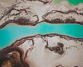 Aerial view of an abstract blue and turquoise clay lake, Art-sur-Meurthe, France.