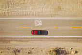 Aerial view of a red car on famous Historical Route 66, California, San Bernardino County, United States.