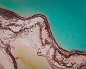 Aerial view of an abstract blue and turquoise clay lake, Art-sur-Meurthe, France.