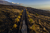 Aerial view of a road covered with ashes from Cumbre Vieja eruption, a Volcano in La Palma island, Canary Islands, Spain.