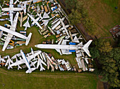 Aerial view of an abandoned airplane and helicopter graveyard with rusty metal aircraft collection, Zruc Senec, Czech Republic.