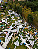 Zruc Senec, Czech Republic - 12 September 2024: Aerial view of an abandoned airplane graveyard with rusty aircraft and helicopters, Zruc Senec, Czech Republic.