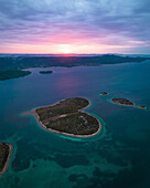 Aerial view of heart-shaped love island at sunset surrounded by the blue Adriatic Sea, Galesnjak, Croatia.