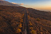 Aerial view of a road covered with ashes from Cumbre Vieja eruption, a Volcano in La Palma island, Canary Islands, Spain.