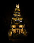 Aerial view of illuminated catholic church surrounded by serene garden and majestic stairs at night, Lamego, Portugal.