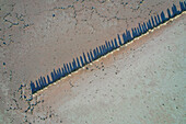 Aerial view of abstract salt mounds creating unique patterns in a barren landscape, St Kilda, Australia.